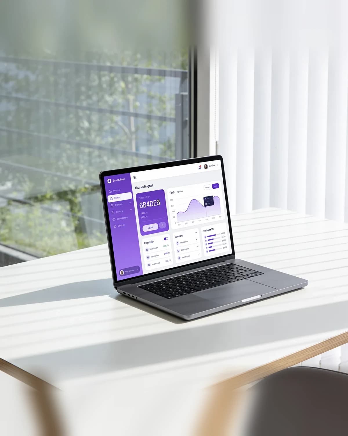 Laptop with a purple app dashboard on a white desk